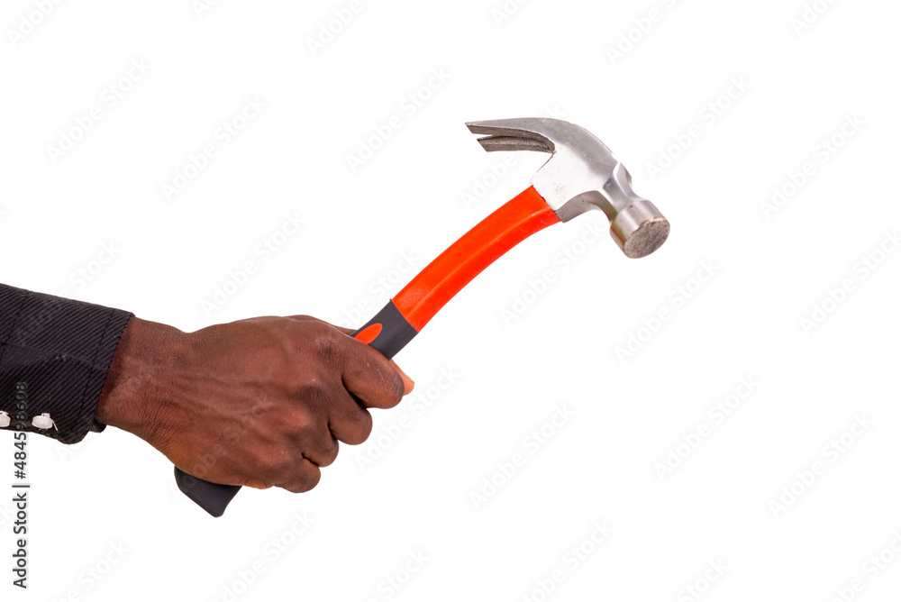 hand of an unknown person holding a hammer. hand of an unknown person holding a hammer.