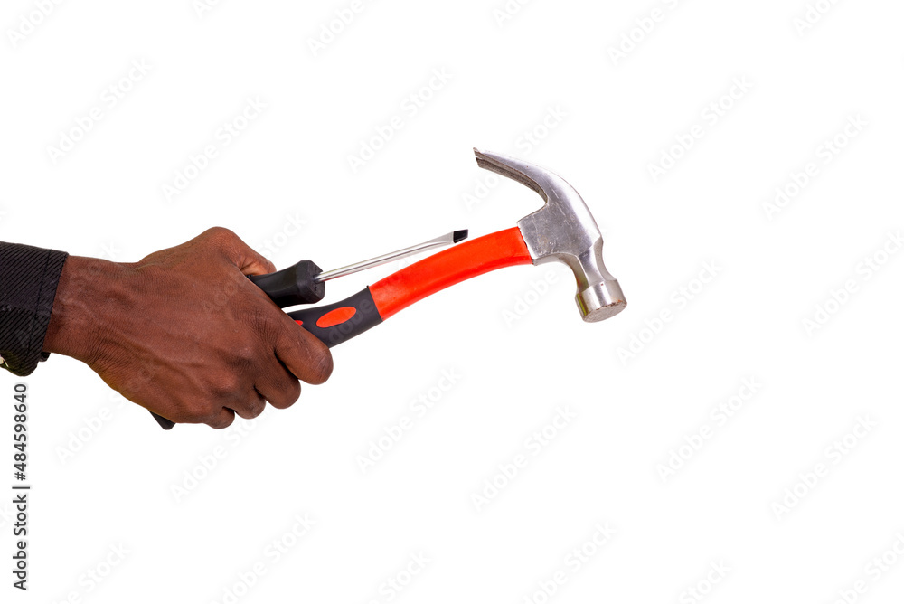 hand of unknown person holding hammer and screwdriver. hand of unknown person holding hammer and screwdriver.