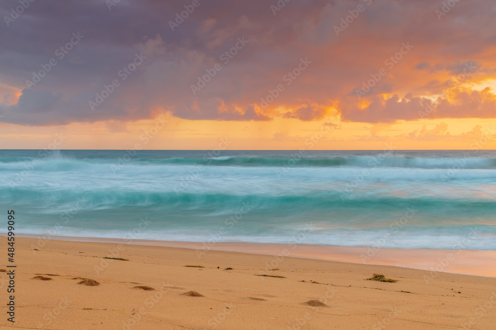 Sunrise at the seaside with waves and clouds Sunrise at the seaside with waves and clouds