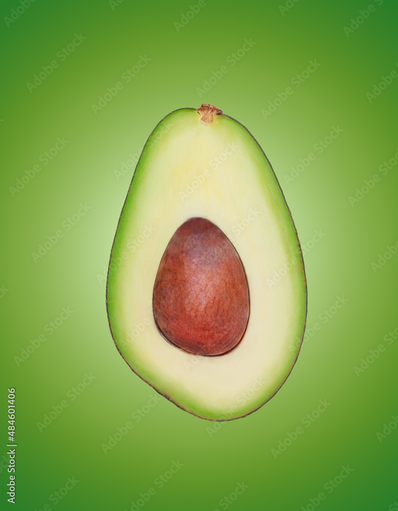beautiful set of avocado cut in half on a light green background