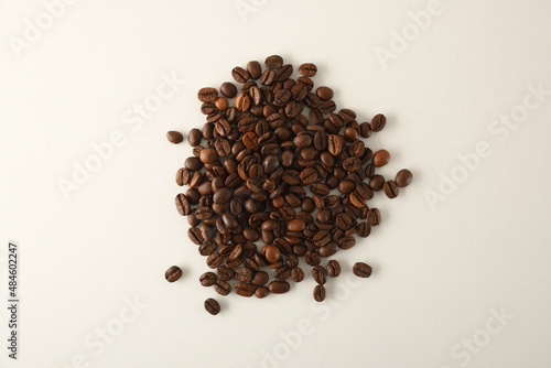 Pile of coffee beans in the center of white table