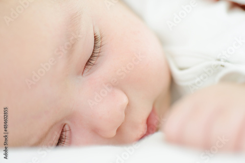 Baby newborn sleeping on the white blanket
