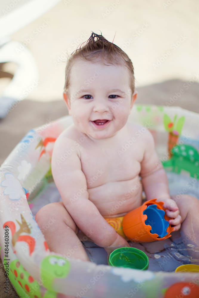 Baby boy in childs swimming pool Baby boy in childs swimming pool