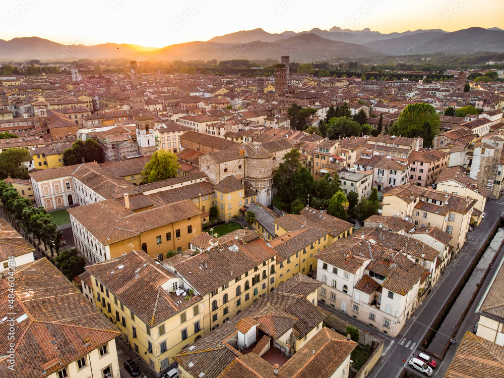 Aerial sunset view of famous Lucca city, known for its intact Renaissance-era city walls and well preserved historic center. Tuscany, Italy.