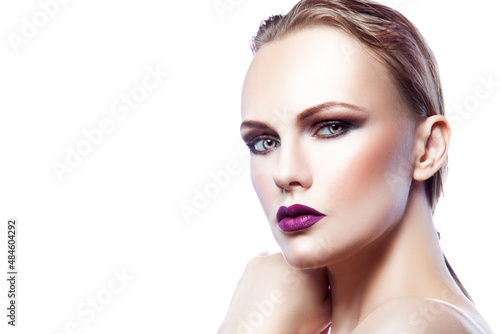 Beauty portrait of a woman with makeup. Copy space on white