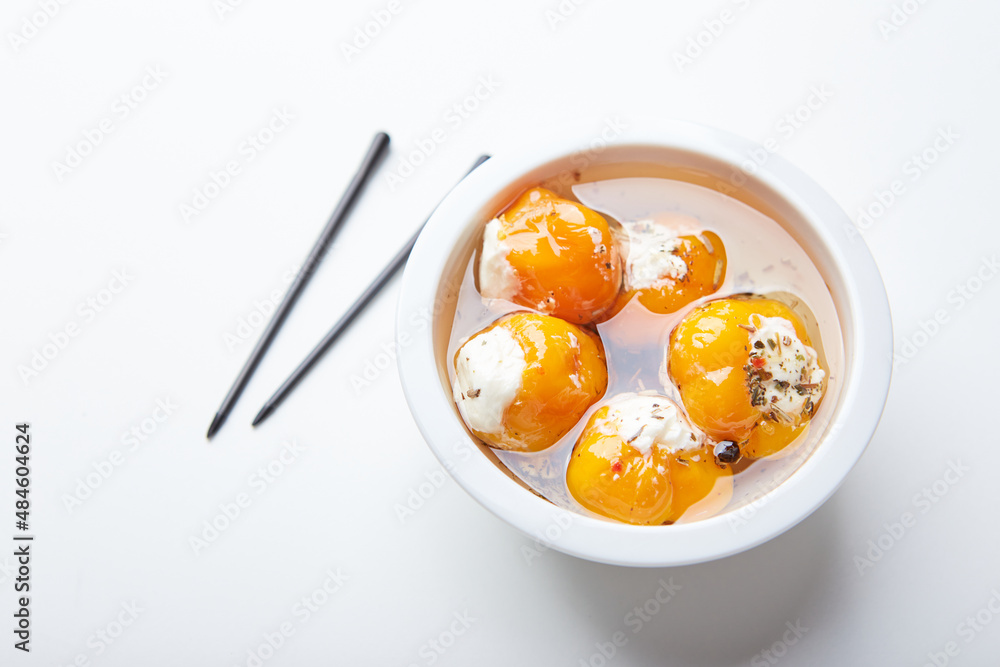 Pickled hot yellow tiny cherry peppers stuffed with soft cream or ricotta cheese. Delicious snack Pickled hot yellow tiny cherry peppers stuffed with soft cream or ricotta cheese. Delicious snack
