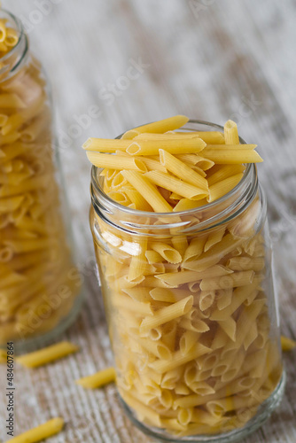 Transparent glass jars with raw pasta