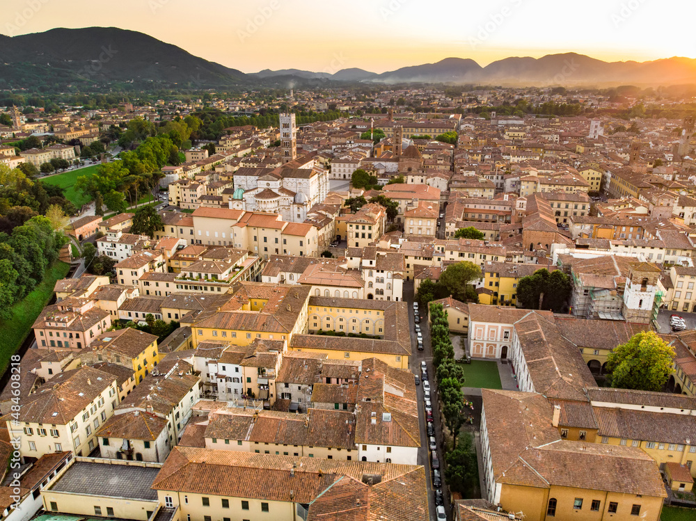 Aerial sunset view of famous Lucca city, known for its intact Renaissance-era city walls and well preserved historic center. Tuscany, Italy.