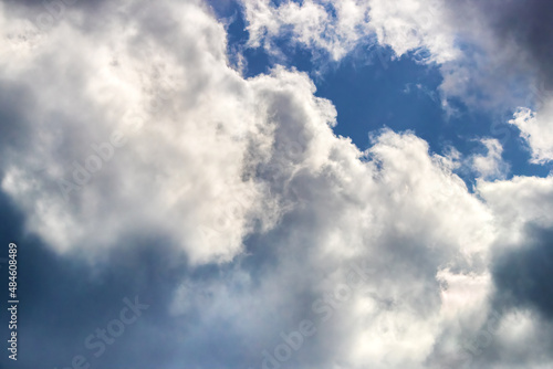 Blue sky and cumulonimbus storm cloud background with space for text or use as a backdrop, overlay or compositing element.
