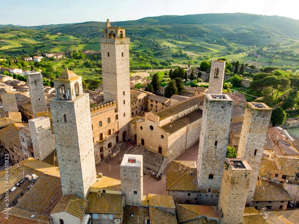 Aerial view of famous medieval San Gimignano hill town with its skyline of medieval towers, including the stone Torre Grossa. UNESCO World Heritage Site. - obrazy, fototapety, plakaty 