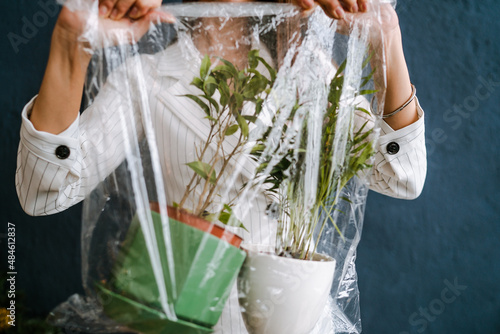 Girl holding plants in a salofan bag photo