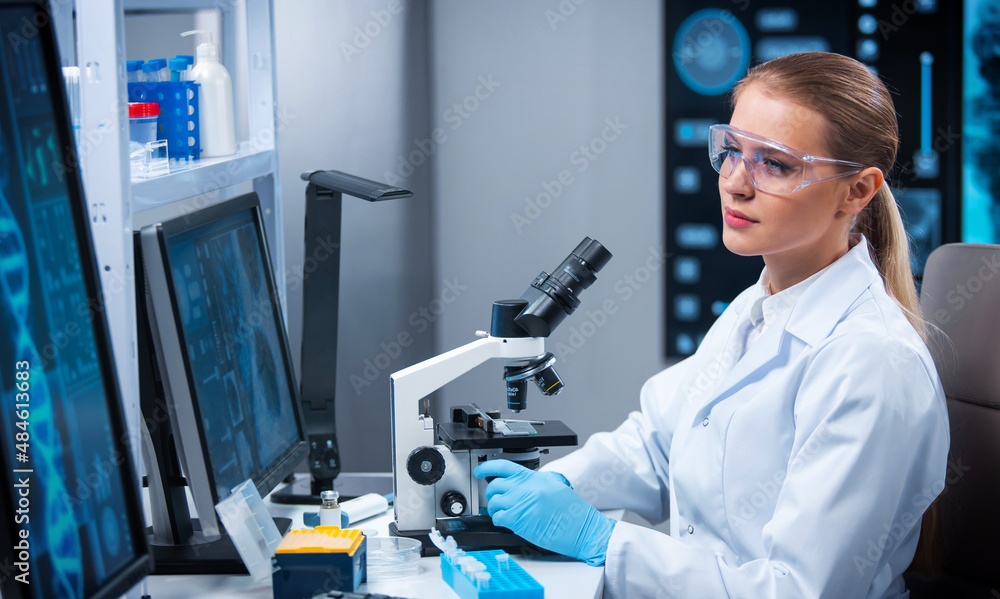 Female doctor works in a modern scientific laboratory using equipment and computer technologies. The scientist does research and develops new vaccines. Science and healthcare concept. Female doctor works in a modern scientific laboratory using equipment and computer technologies. The scientist does research and develops new vaccines. Science and healthcare concept.