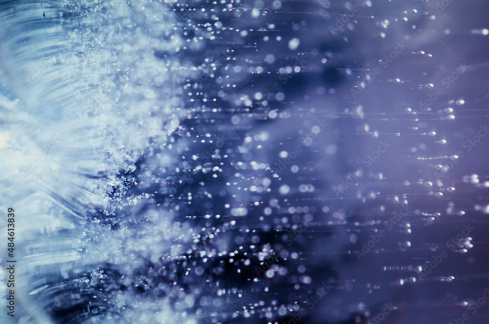 Obraz premium Abstract ice texture. Small bubbles with tails. Abstract nature background. Colorful Background of blue ice inside.