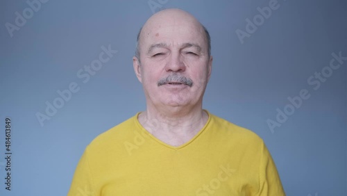 Senior hispanic man relaxing with closed eyes breathing deeply.