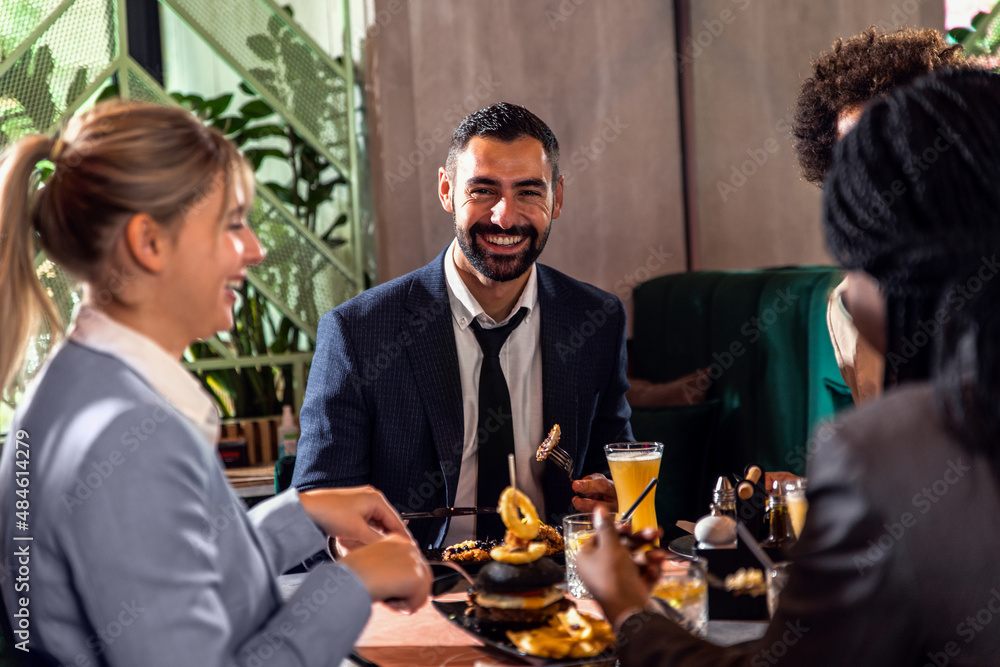 Portrait of young business man in restaurant whit his colleagues. Portrait of young business man in restaurant whit his colleagues.