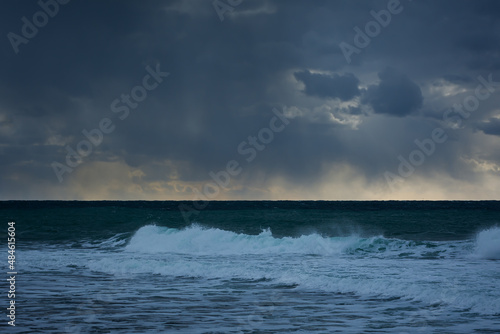 Storm clouds over the sea are black and blue. A hurricane is coming, a downpour. Natural sinister background. Storm warning. Weather disasters. The sea is a gloomy landscape. Gloomy seascape