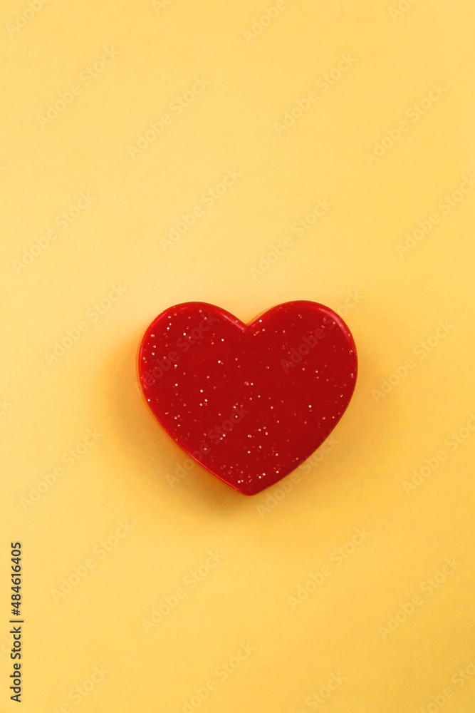 Small red heart on bright yellow background. Love concept. Flat lay. Small red heart on bright yellow background. Love concept. Flat lay.