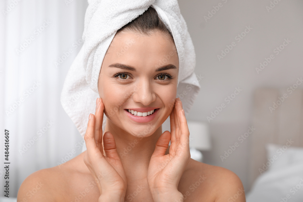 Beautiful young woman with hair wrapped in towel at home Beautiful young woman with hair wrapped in towel at home