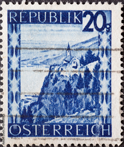 Austria - circa 1946 : a postage stamp from Austria, showing a landscape in Austria: Chapel at Gebhardsberg (Vorarlberg) photo