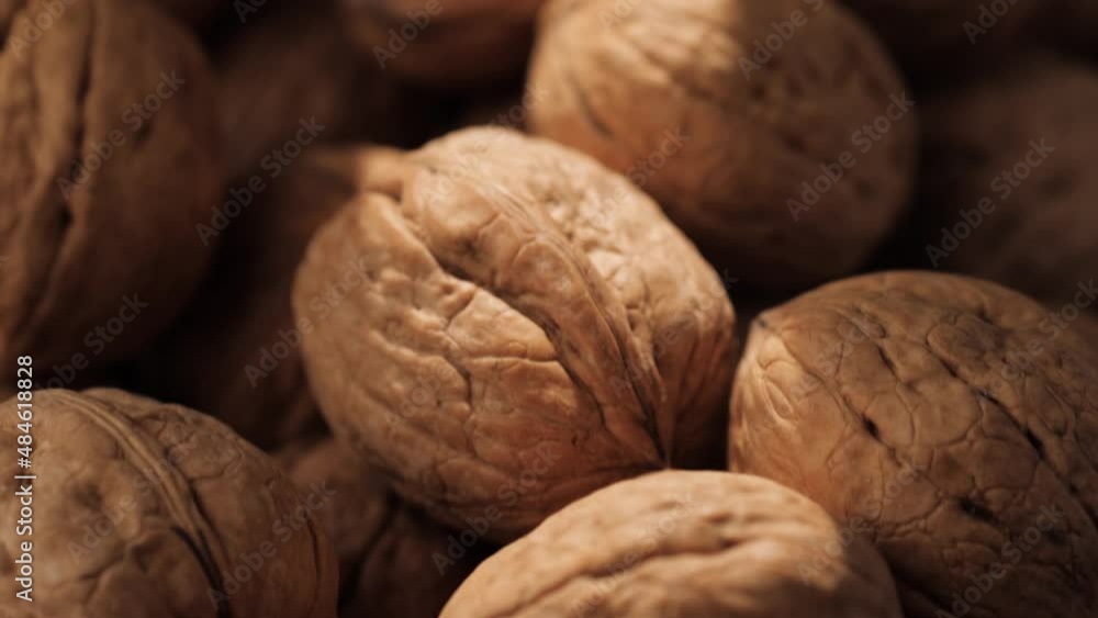 Walnuts. Close-up of walnuts in shadow on which ray of sunlight falls, camera slowly moves down to show nuts Walnuts. Close-up of walnuts in shadow on which ray of sunlight falls, camera slowly moves down to show nuts