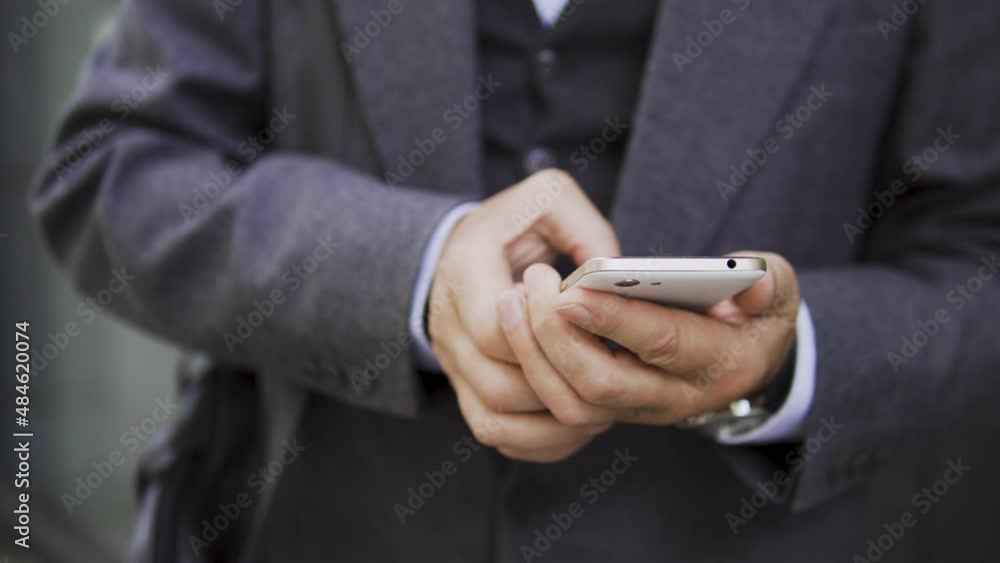 Man typing message on smartphone, looking for route in online maps application Man typing message on smartphone, looking for route in online maps application