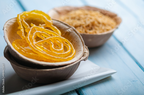 Indian popular sweet - Jalebi, served in a eco-friendly bowl with spicy Sev Bhujia (fried noodles). photo