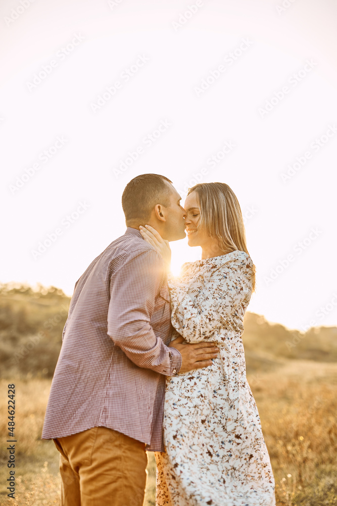 couple in love caucasian man and woman hugging holding hands kissing outdoors couple in love caucasian man and woman hugging holding hands kissing outdoors