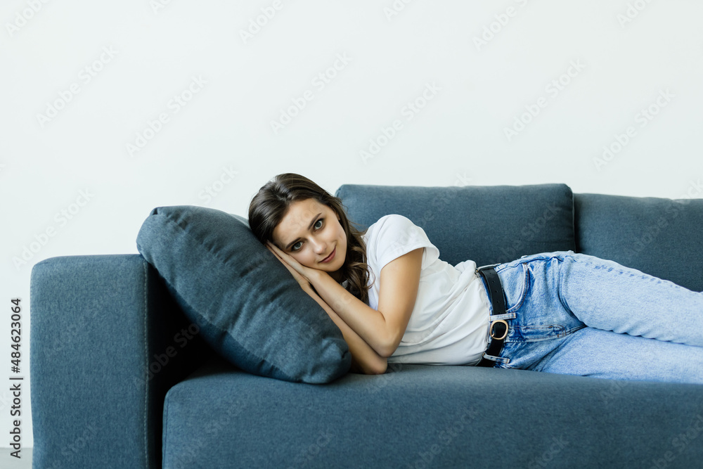 Portrait of woman lying on sofa and slipping indoor shoot. Portrait of woman lying on sofa and slipping indoor shoot.