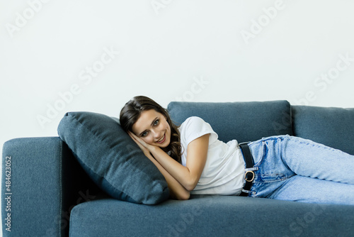 Young woman lying on comfy couch sleeping or having day nap resting alone