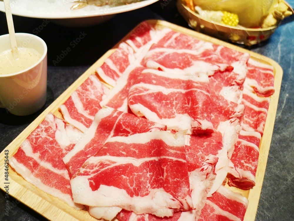 Pile of fresh red tender snowflake beef slices on a tray