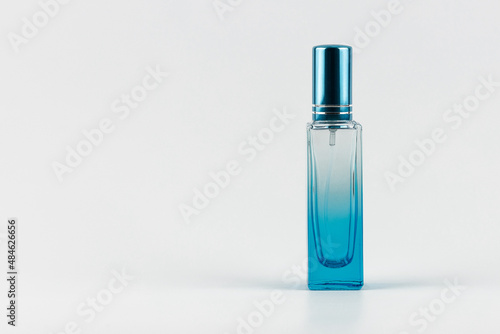 unbranded transparent perfume blue glass sprayer minimal style concept. blue flacon of essence perfume for your text and design