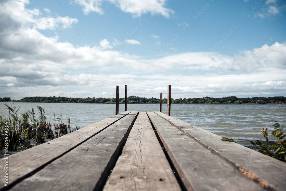 Beautiful wooden pier near the river bank