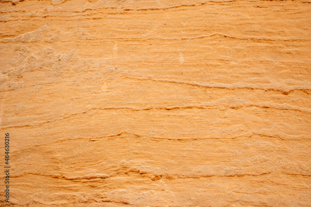 Textural sand, with relief surface, multi-colored layers and different in size of granules, in outdoor sand career, after mining ore and sand for construction. Textural sand, with relief surface, multi-colored layers and different in size of granules, in outdoor sand career, after mining ore and sand for construction.