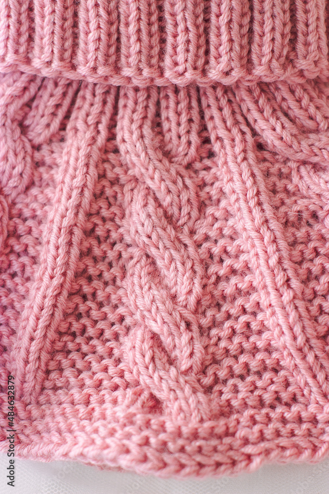 Pink knitted scarf on a white background