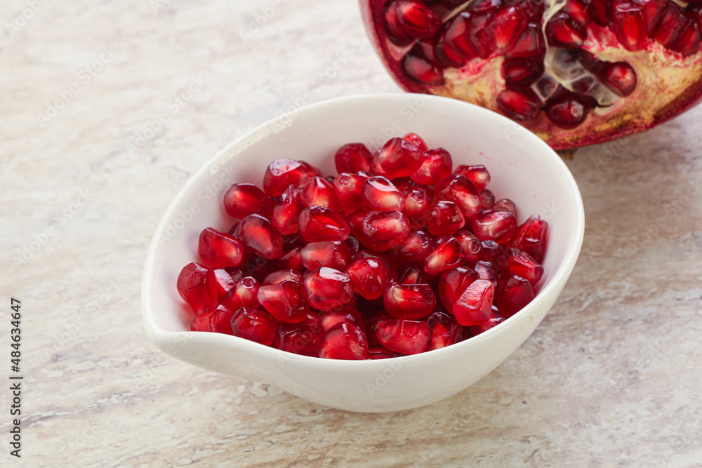 Ripe red Pomegranate seeds in the bowl Ripe red Pomegranate seeds in the bowl