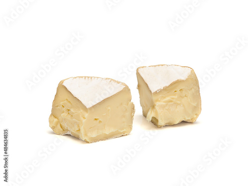 two pieces of fresh brie cheese isolated on white background