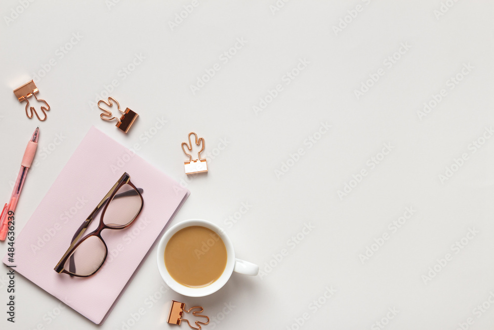 Top view of the desktop. Cup of coffee glasses notepad on the table. Flat lay copy space Top view of the desktop. Cup of coffee glasses notepad on the table. Flat lay copy space