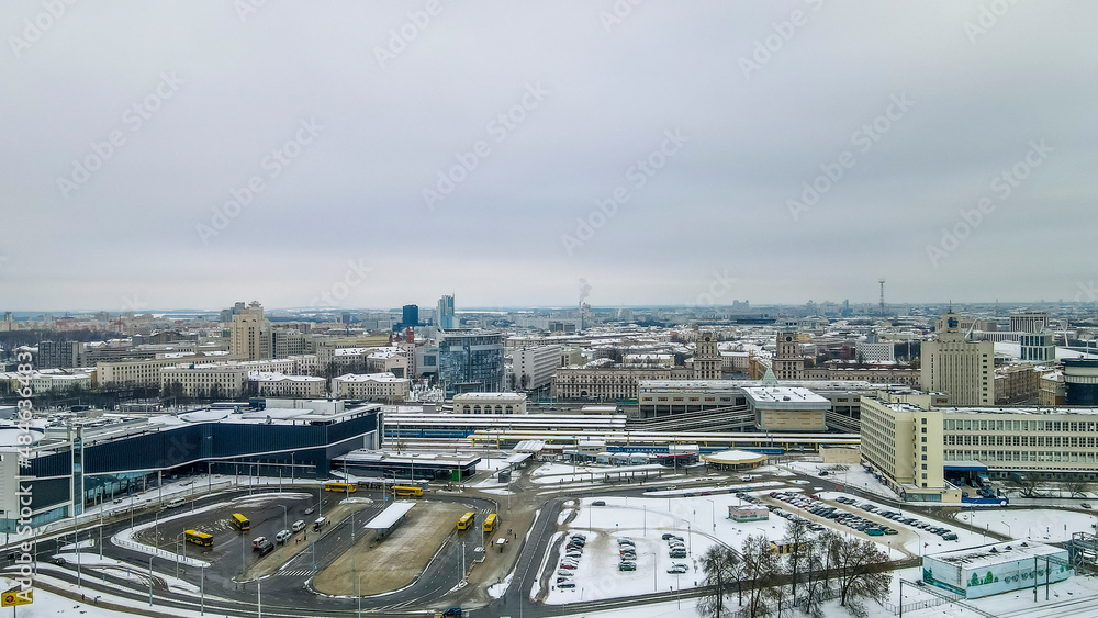 Aerial view of city transport hub railway and bus station. Aerial Central railroad station yard area in Minsk in winter.