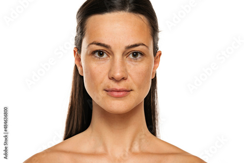 Konstfotografi a young smiling woman without makeup with long hair on a white