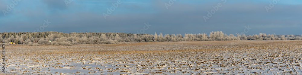 Winter farmland scenery landscape under snow with trees on background. Winter landscape with snow covered countryside. Winter farmland scenery landscape under snow with trees on background. Winter landscape with snow covered countryside.