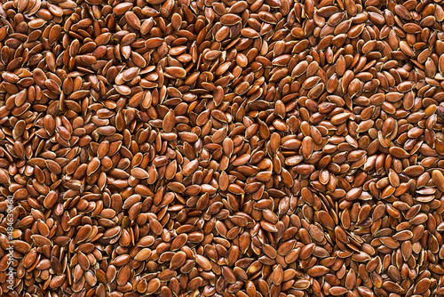 Linseed or flaxseed background, brown flax seeds. Flat lay, copy space