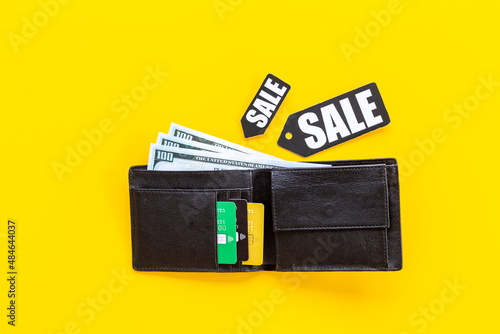 Sale tag and wallet with banknotes and bank cards