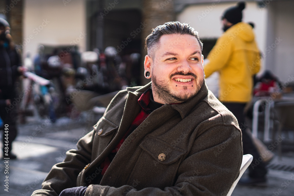 man with beard white hair and stretched ears smiling man with beard white hair and stretched ears smiling