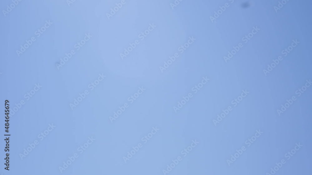 woman throwing silver confetti against the sky close-up woman throwing silver confetti against the sky close-up