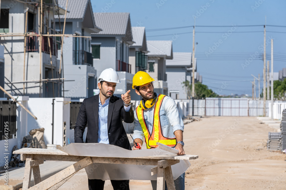 Architectural engineer meeting and working with blueprints at construction site,discussing,designing,Construction concept. Architectural engineer meeting and working with blueprints at construction site,discussing,designing,Construction concept.