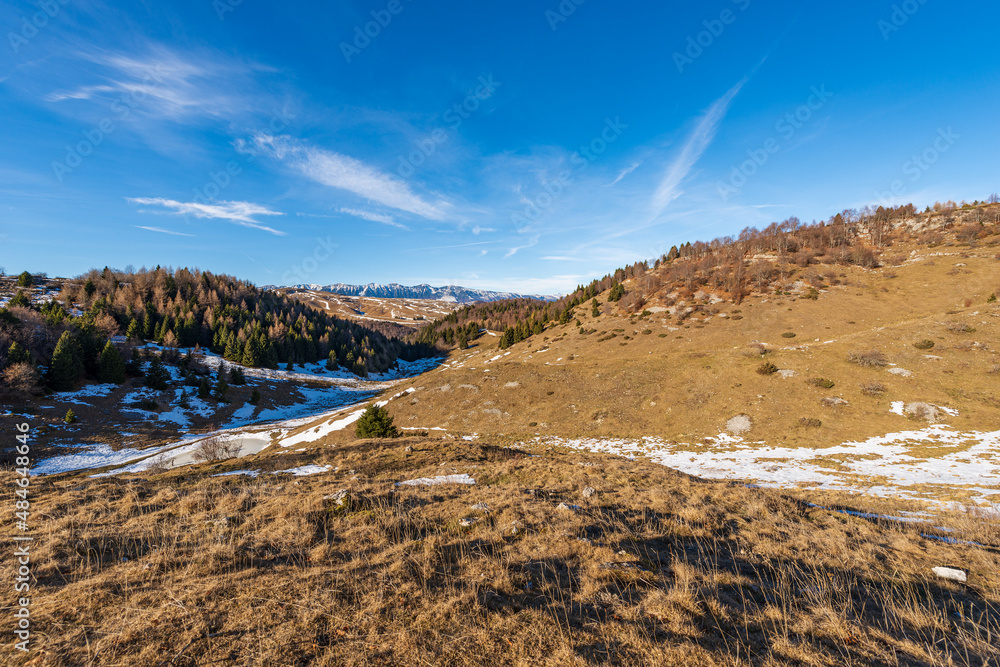Lessinia Plateau Regional Natural Park (Altopiano della Lessinia) and mountain range of Monte Baldo (Baldo Mountain), winter landscape, Veneto and Trentino-Alto Adige, Italy, Alps, Europe. 