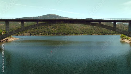 Aerial drone point of view arch bridge across El Burguillo Reservoir, located along Alberche river in province of Avila. Spain