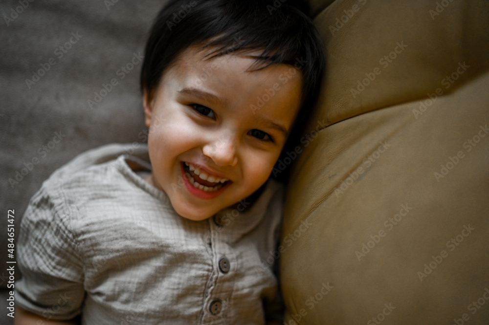 little boy at home having fun and jumping on the couch little boy at home having fun and jumping on the couch