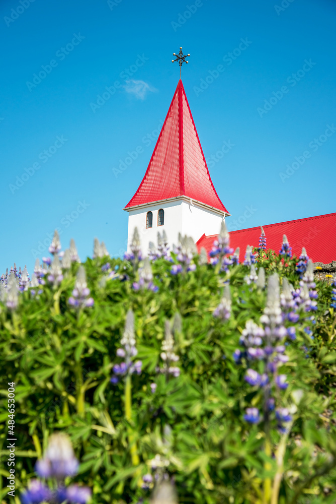 The famous Vik church (Vikurkirkja) on the background of the sea and the fingers of the troll in Iceland. place of pilgrimage. Impressive landscape. Exotic countries. Amazing places.