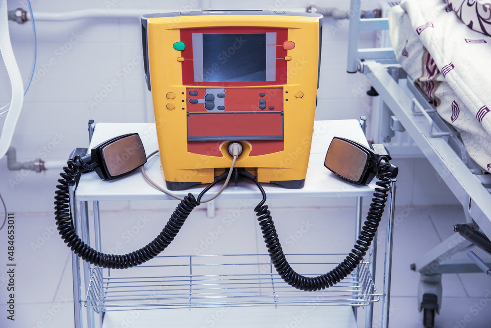 defibrillator on the table in the hospital near the patient's bed.